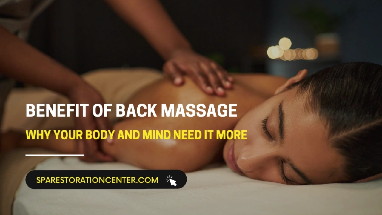 A woman lying face down on a massage table receiving a relaxing back massage from a professional therapist in a dimly lit spa setting.